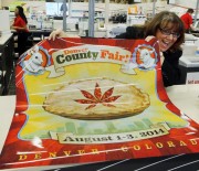 Dana Cain, director of the Denver County Fair, shows a poster advertising the fair at a print shop in Denver, Monday Jan. 27, 2014.  Colorado's Denver County is adding cannabis-themed contest to its 2014 summer fair. (Associated Press file)