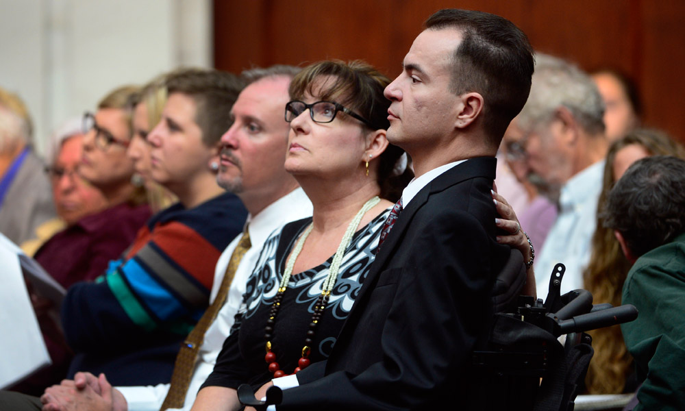 Brandon Coats, right, waits for the proceedings to begin with his mother Donna Scharfenberg sitting by his side. The Colorado Supreme Court heard arguments Tuesday, Sept. 30, 2014, in the case of Brandon Coats, a quadriplegic medical marijuana patient who was fired from his job at Dish Network after testing positive for marijuana. (Kathryn Scott Osler, The Denver Post)  