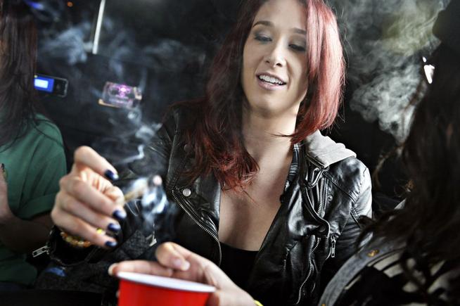 Beth Bice of Charlotte, N.C., smokes a joint on the bus during a marijuana tour hosted by My 420 Tours in Denver on Dec. 6, 2014. (Denver Post file)