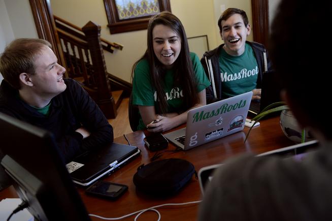 From left, Isaac Dietrich, Hyler Fortier and Austin Hayslip discuss a business brochure during a staff meeting Thursday at MassRoots in Denver. MassRoots' marijuana-centric social media app was removed from Apple's App Store in November.  (Craig F. Walker, The Denver Post)