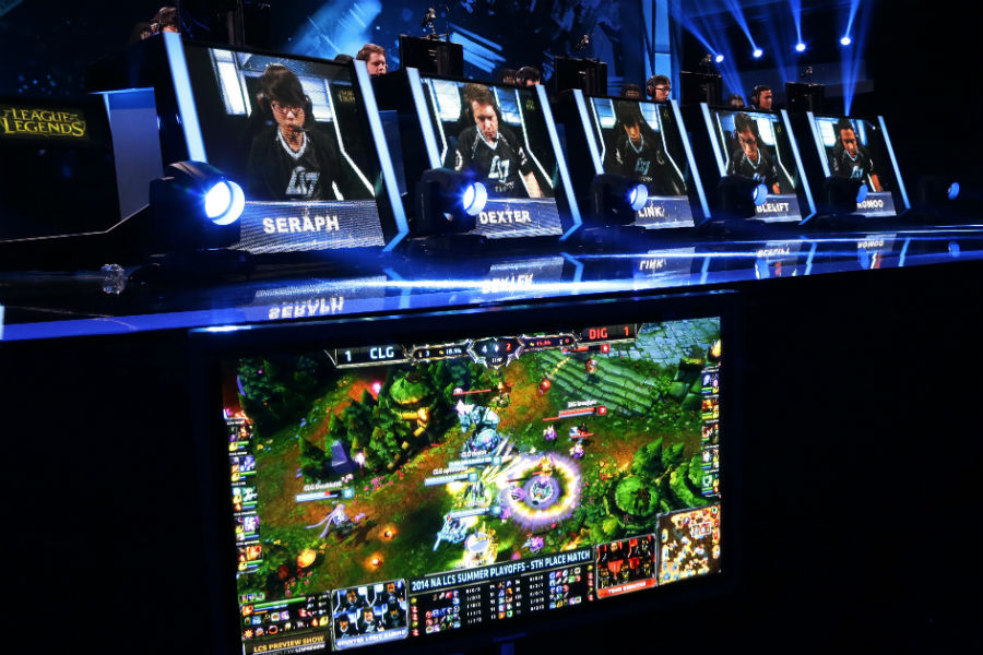 The names and faces of gamers are shown as they compete in a round of the League of Legends championship series video game competition in August 2014. (Ted S. Warren, AP)