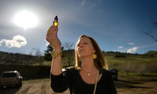 Ana Watson holds a bottle of cannabidiol oil she will administer to her son Preston in an effort to try and control his seizures on April 13, 2014 in Colorado Springs. (Joe Amon, Denver Post file)