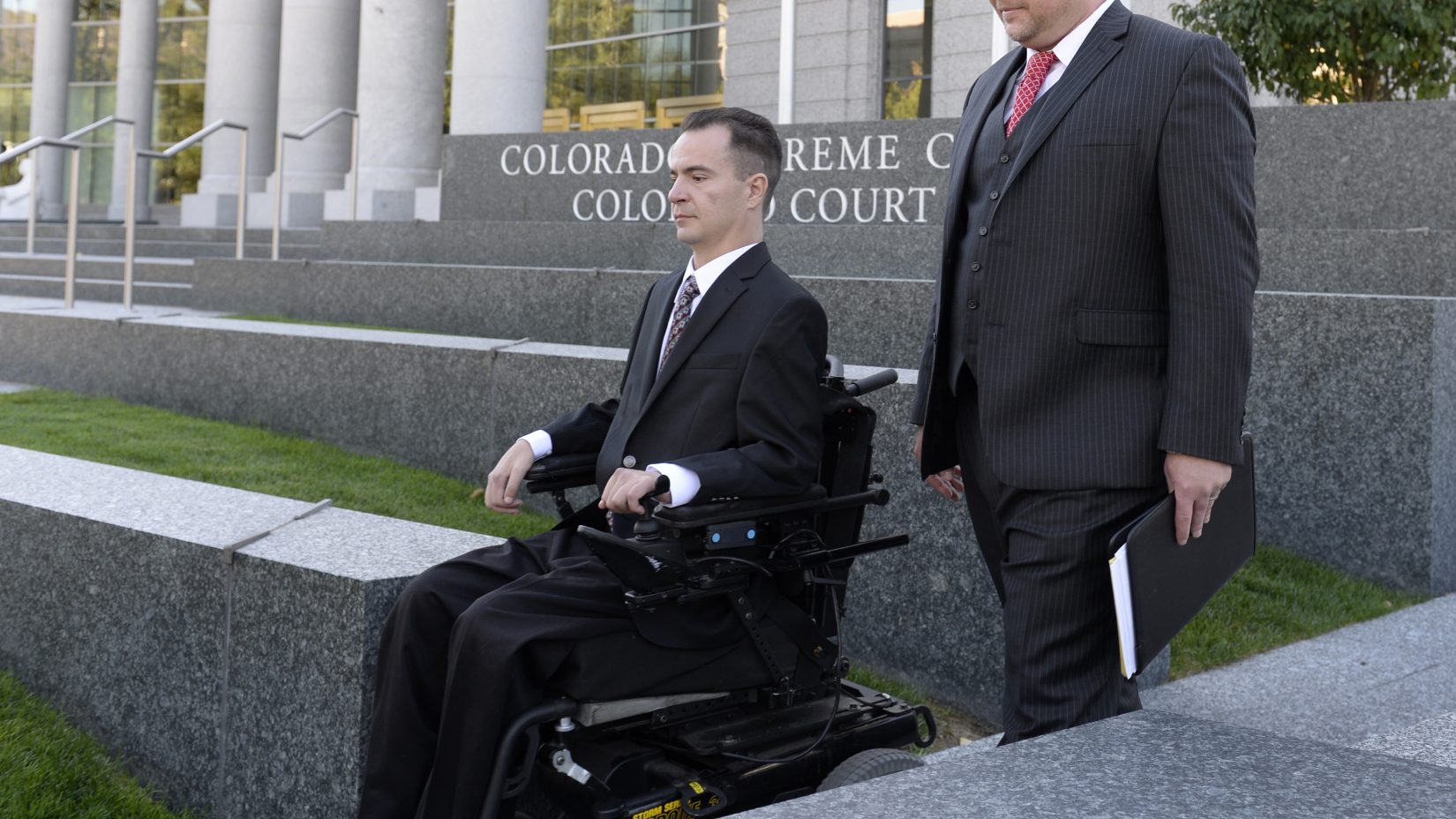 Brandon Coats leaves the courthouse at the end of the hearing with his attorney Michael Evans, right. (Kathryn Scott Osler, The Denver Post)