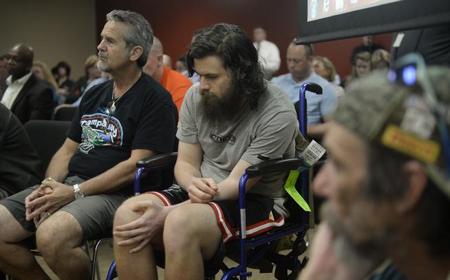 Christopher Latona,  center, and his dad Mike Latona, left, both testified in support of approving medical marijuana for PTSD at a Colorado Board of Health hearing July 15, 2015. Christopher has suffered from PTSD since returning from serving in Afghanistan. (Cyrus McCrimmon, Denver Post file)