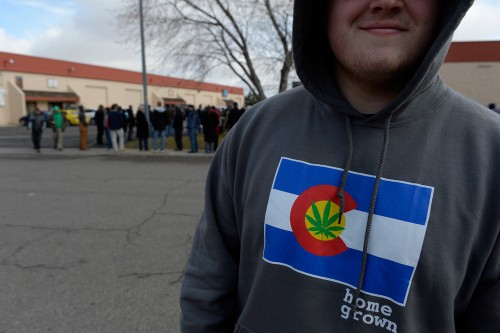 Colorado collected $66.1 million in marijuana taxes in the first year of recreational sales. Seen here, a line stretches outside  BotanaCare 21+ in Northglenn on Jan 1, 2014. (Denver Post file)