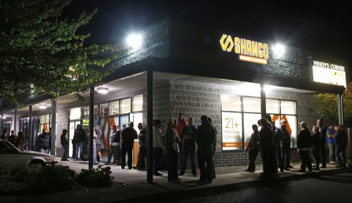 Customers line up outside of Shango Premium Cannabis, in Portland, Ore., late Wednesday, Sept. 30, 2015, in anticipation of recreational marijuana sales that started at midnight, Oct. 1. (Timothy J. Gonzalez, The Associated Press)