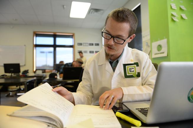 Carter Baird looks at notes at CanopyBoulder. Baird is a member of the startup company, which develops cannabis technologies and ideas. (RJ Sangosti, The Denver Post)