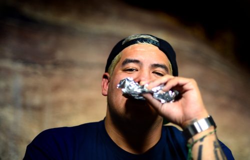 MORRISON, CO - June 27, 2016: Guitarist and singer Rome Ramirez takes a big bite out of the Dixie Elixirs Sublime With Rome Orange Dynamite Chocolate Bar in the green room of Red Rocks during an interview with The Cannabist. Sublime with Rome, a touring act made including Eric Wilson of the original Sublime, made an early stop at the infamous Red Rocks Amphitheater on their summer 2016 tour on June 27, 2016. (Photo by Vince Chandler / The Denver Post)
