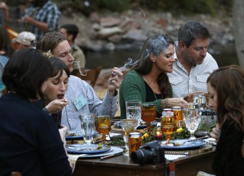 Diners smoke marijuana as they eat dishes prepared by chefs during an evening of pairings of fine food and craft marijuana strains on Oct. 2, 2016. (Brennan Linsley, The Associated Press) 