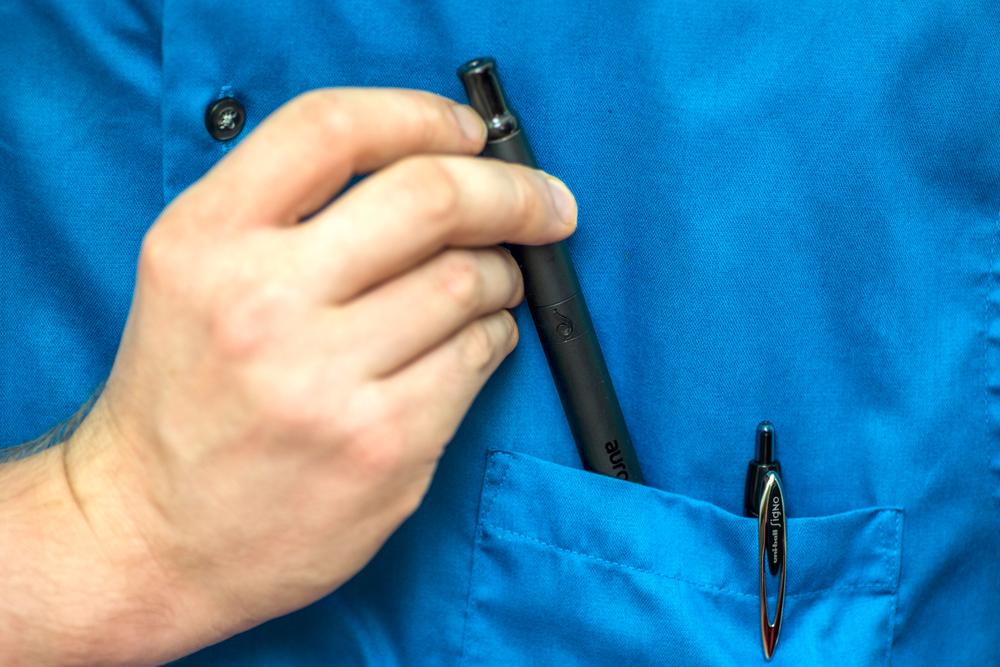 A photo of the Dr. Dabber Aurora being inserted into a shirt pocket.