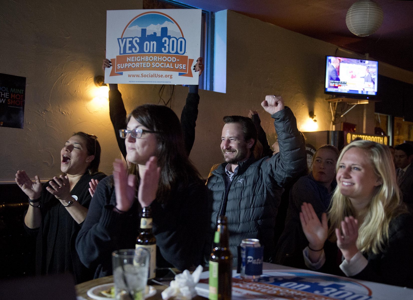 A cheer goes up among supporters of Initiative 300, the Neighborhood-Supported Social Cannabis Consumption Initiative, as they listen to polling updates during an election night watch party at downtown Denver bar El Charrito. (Andy Colwell, The Cannabist)