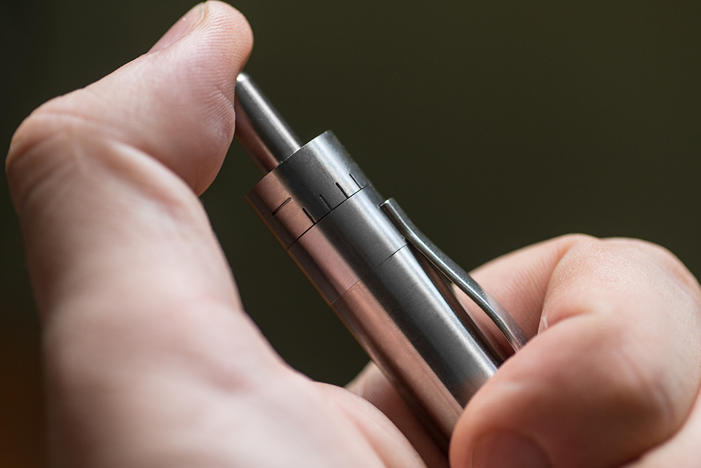 A photo of a hand turning on the Grasshopper vape.